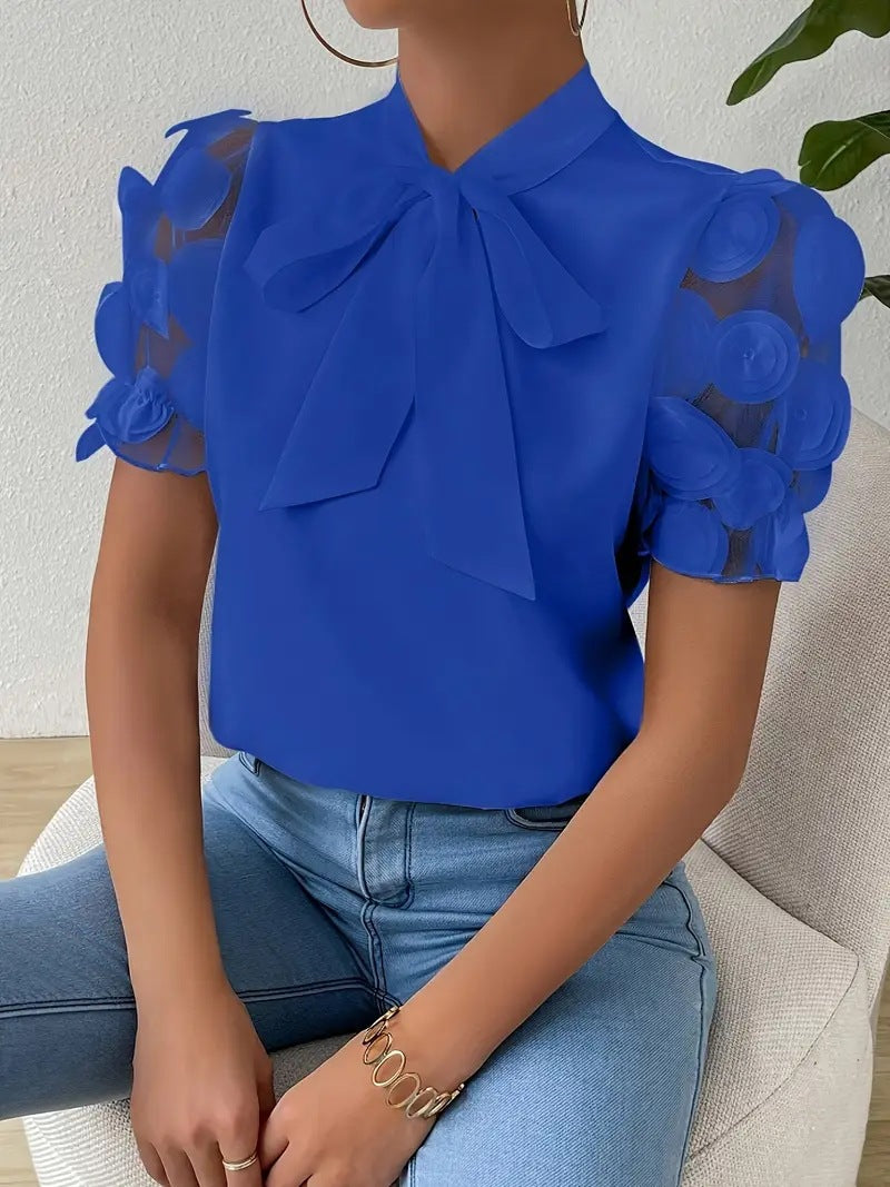 Elegant women’s blouse with a bow and sheer sleeves.